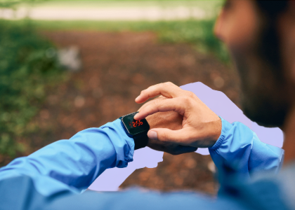 A runner checking their smart watch
