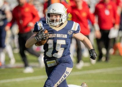 Steph running with an American football
