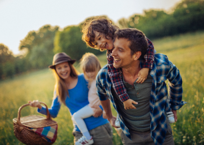 A family with a picnic basket in a field