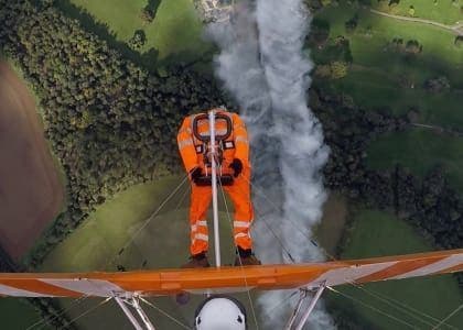 Man stood on wing of airplane