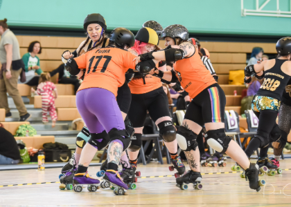 Caroline and a group on roller skates in a gym