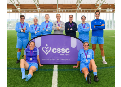 cssc women's football team stood on a football pitch